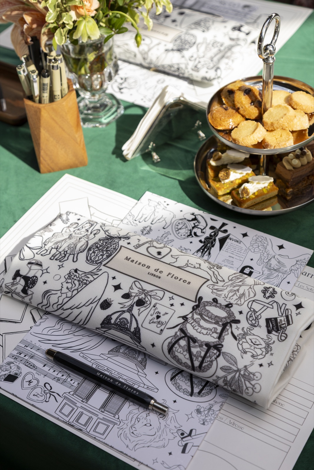 The atelier table — papier carré, fine pens and afternoon tea
